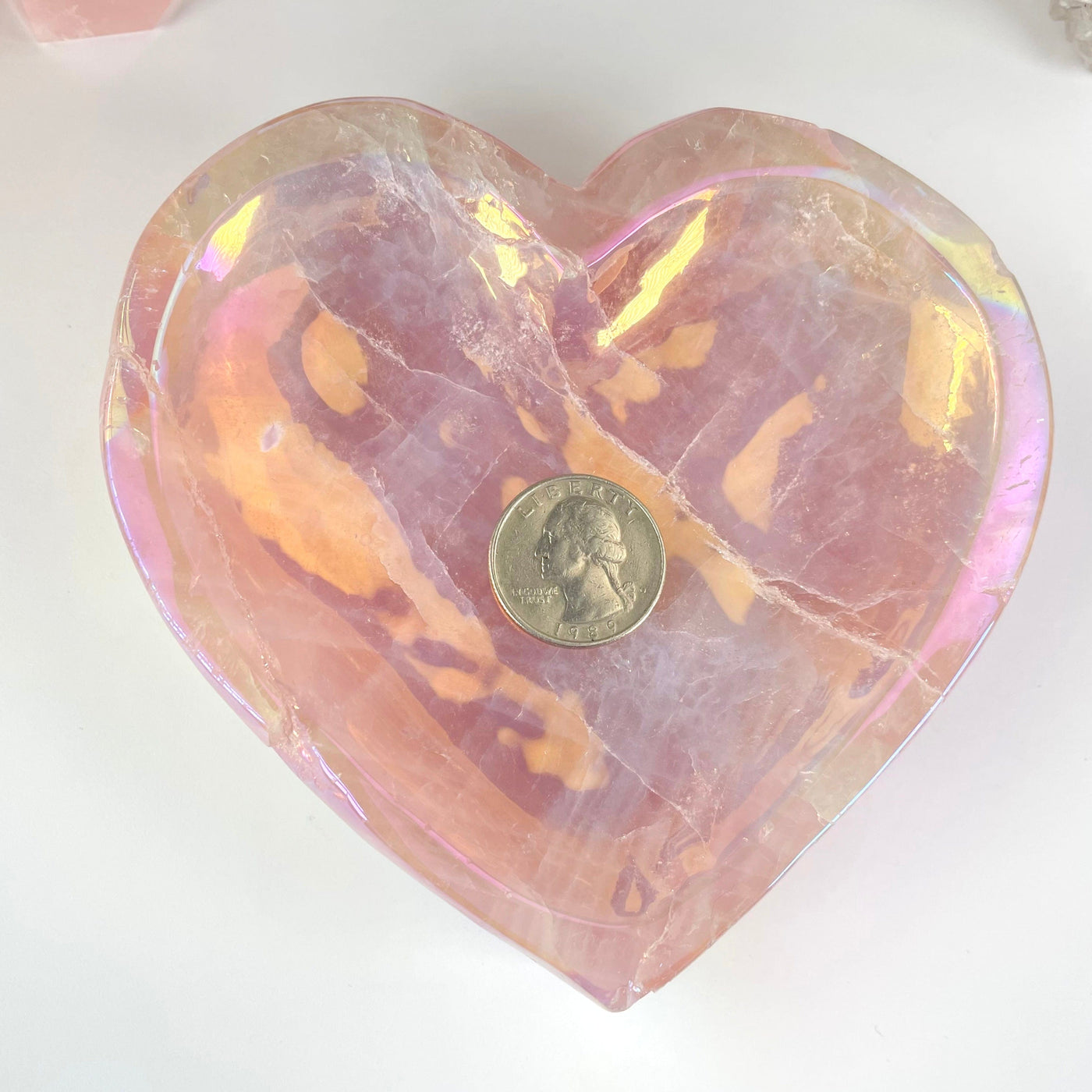 overhead view of angel aura rose quartz heart bowl with quarter for size reference