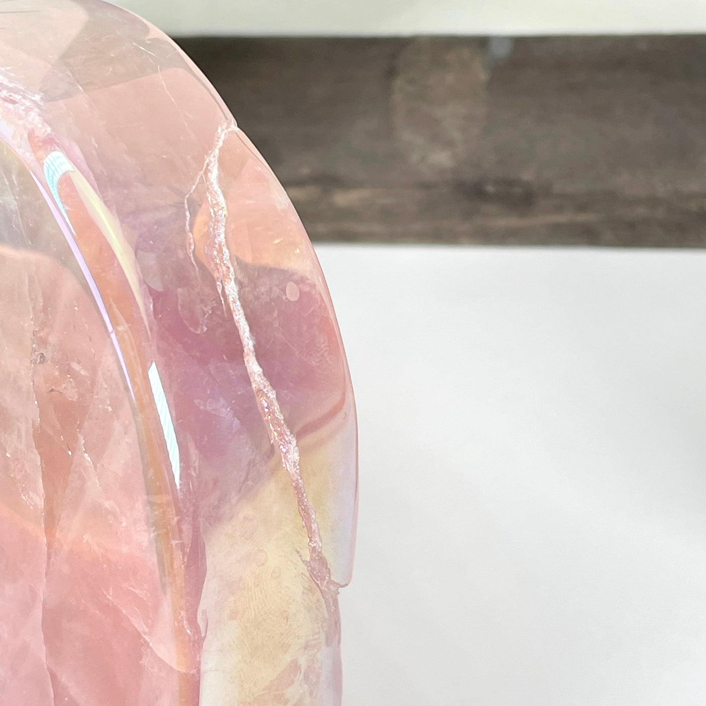 close up of natural crack in angel aura rose quartz heart bowl