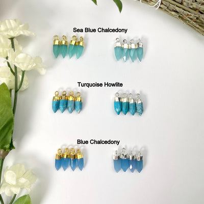 gold and silver sea blue chalcedony, turquoise howlite, and blue chalcedony tiny spike pendant options on display