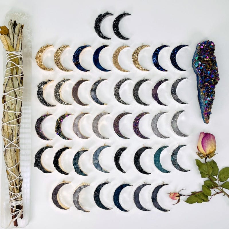 multiple moon crescent pendants displayed to show the differences in the stone types and color options