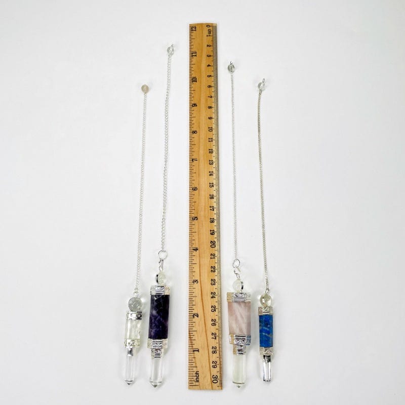 pendulums next to a ruler for size reference 