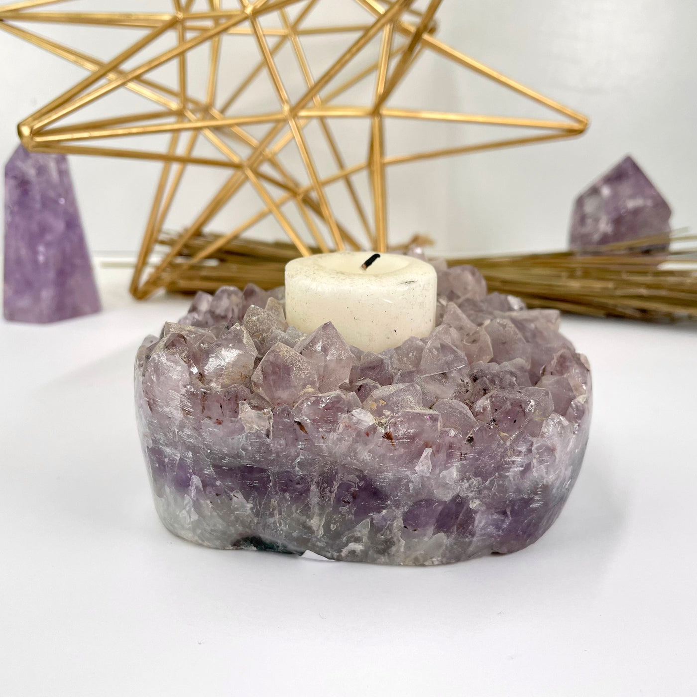 amethyst cluster candle holder with candle on display