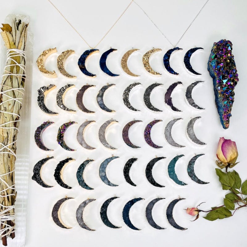 multiple moon crescent pendants displayed to show the differences in the stone types and color options  