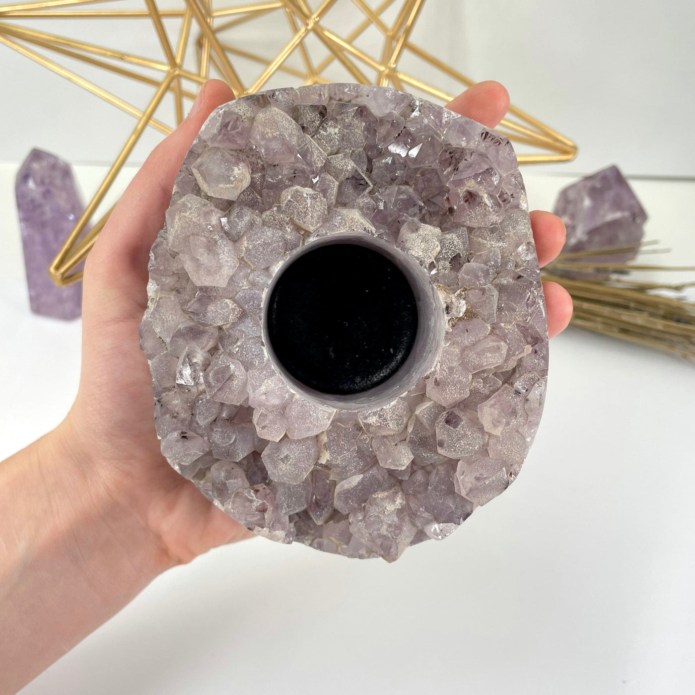 amethyst cluster candle holder in hand for size reference