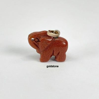close up of goldstone elephant pendant for details