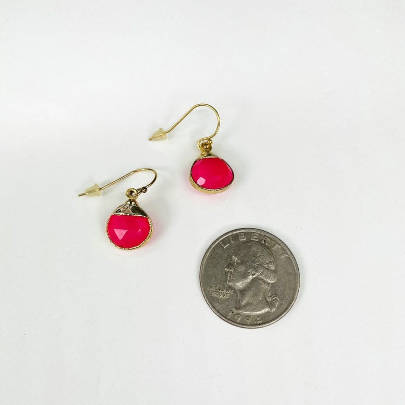 pink chalcedony earrings with an electroplated gold edge next to a quarter for size reference 