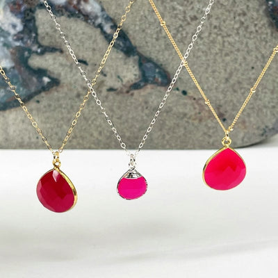multiple pink chalcedony necklaces displayed next to each other 
