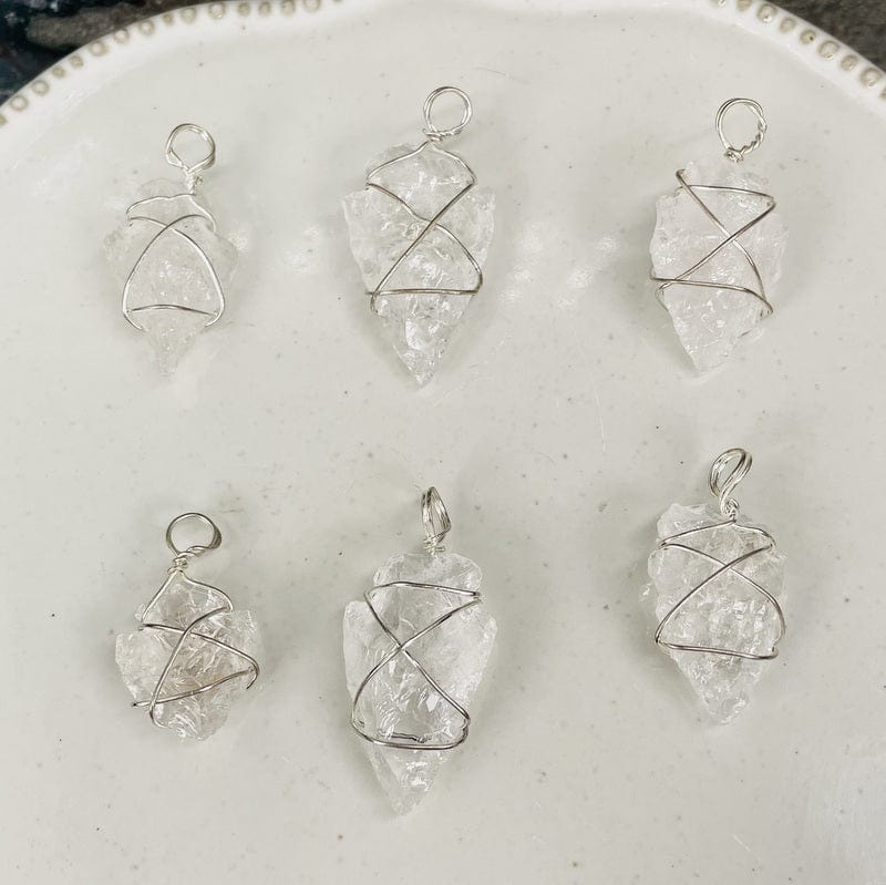 multiple crystal quartz arrowhead craft charms displayed to show the differences in the sizes 