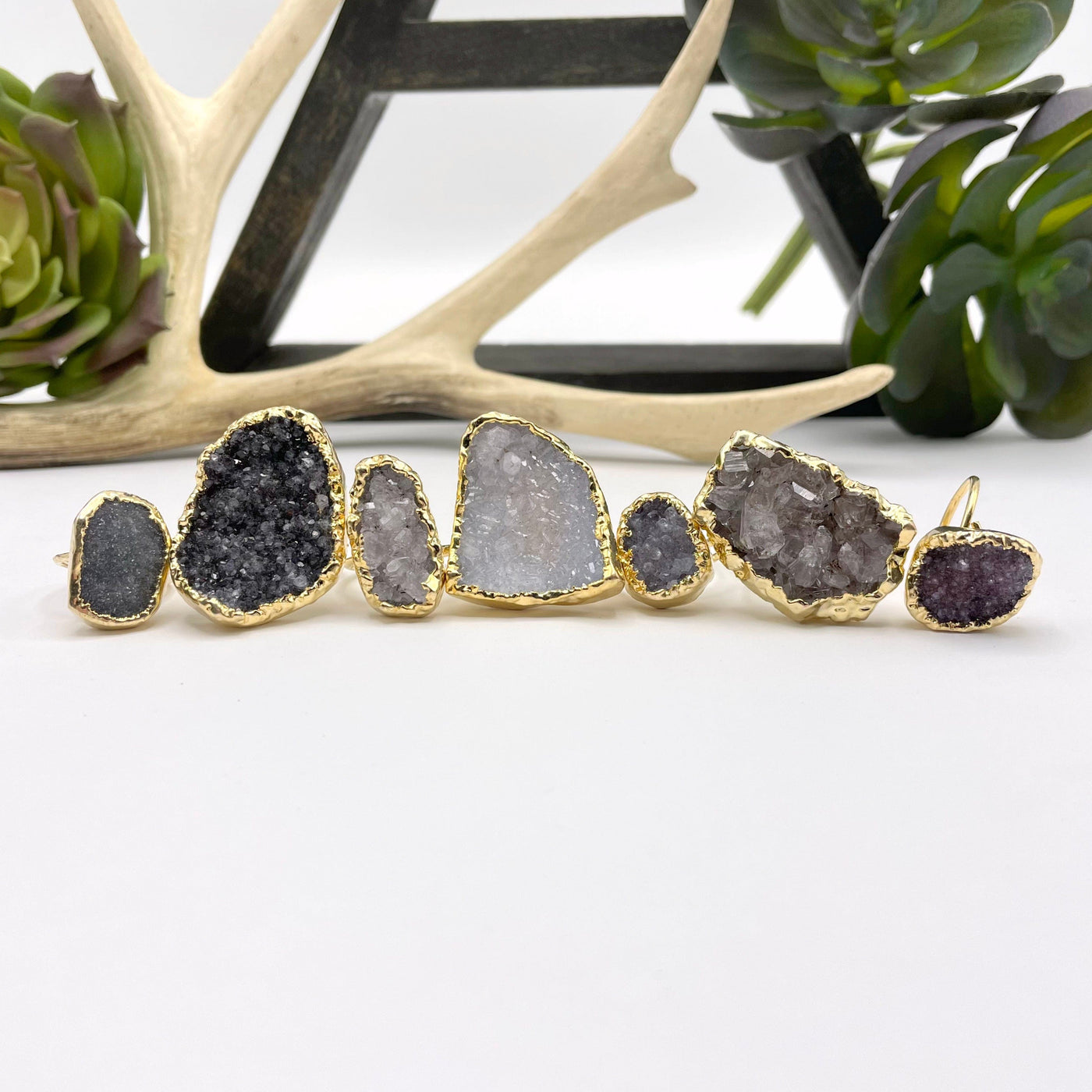 adjustable druzy rings in front of backdrop