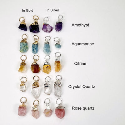 rough stone pendants with gold or silver cap and large hoop bails next to their stone name. available in amethyst, aquamarine, citrine, crystal quartz and rose quartz 