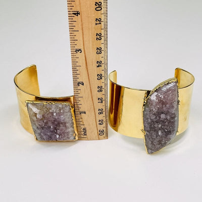 cuff next to a ruler to show the different tallness 