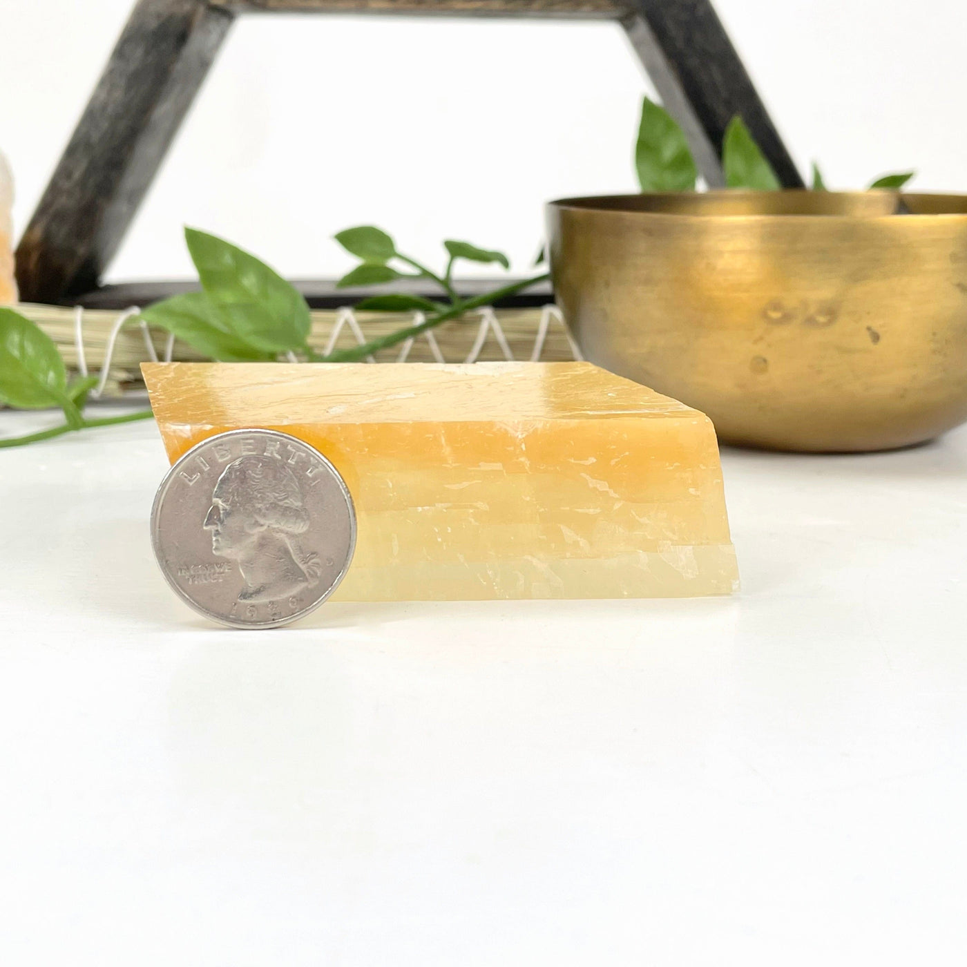 orange calcite cube with quarter for thickness