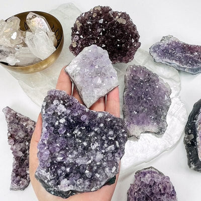 amethyst clusters in hand for size reference 