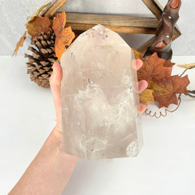 crystal quartz polished point in hand