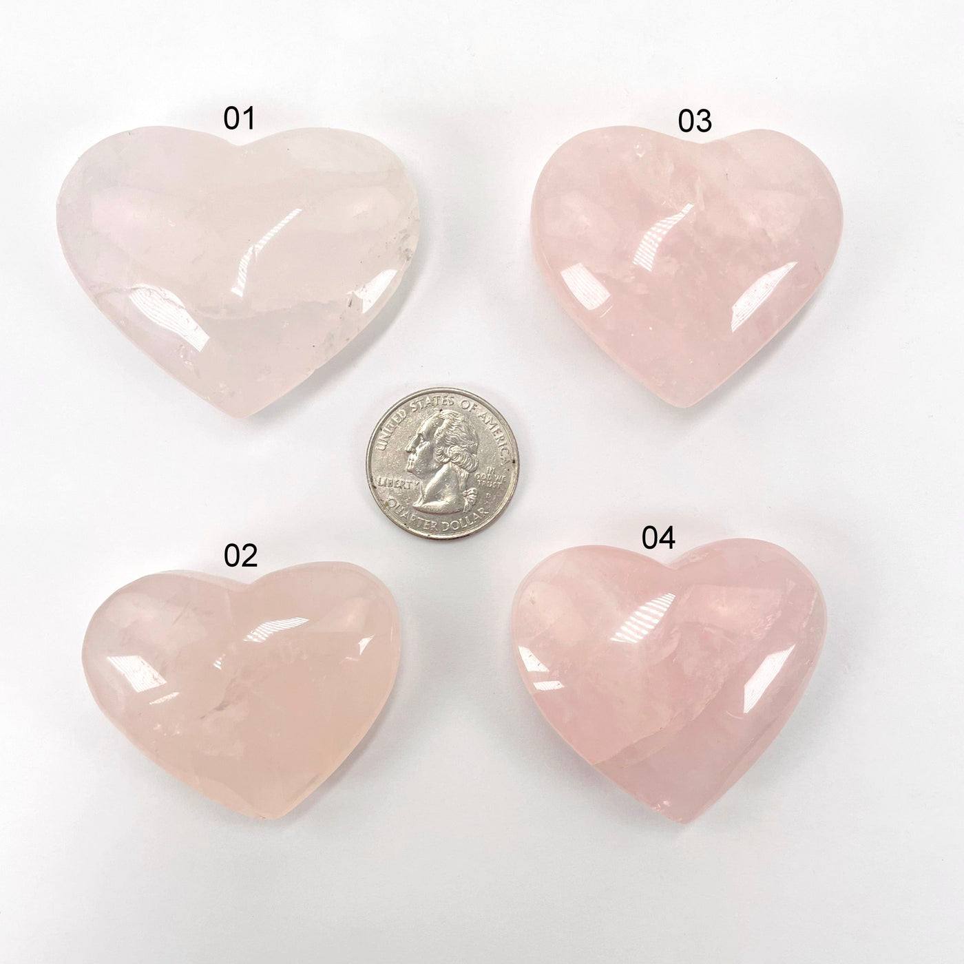 rose quartz polished hearts with quarter for size reference