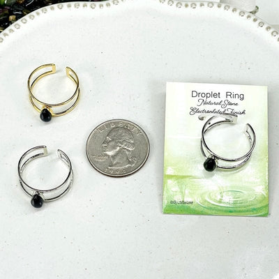 rings next to a quarter for size reference 