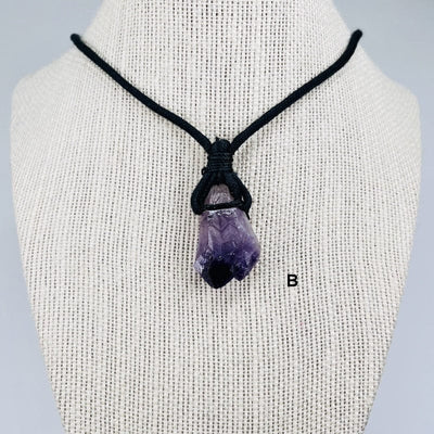 close up of the amethyst on a black cord necklace 