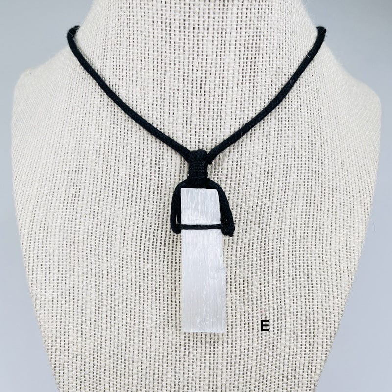 close up of the selenite rod on a black cord necklace 