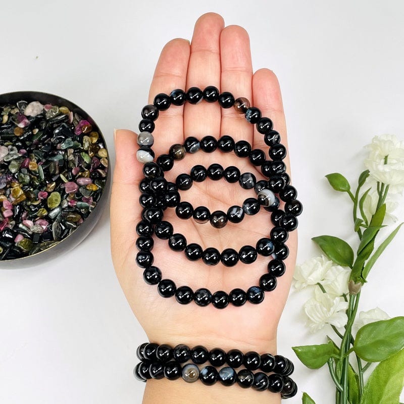 black agate bead bracelets in hand for size reference 