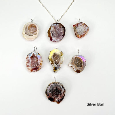 geode pendants with an electroplated silver bail displayed to show the differences in the possible sizes