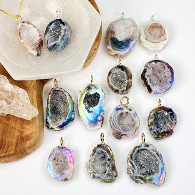 multiple geode pendants displayed next to each other to show the differences in the sizes and colors 