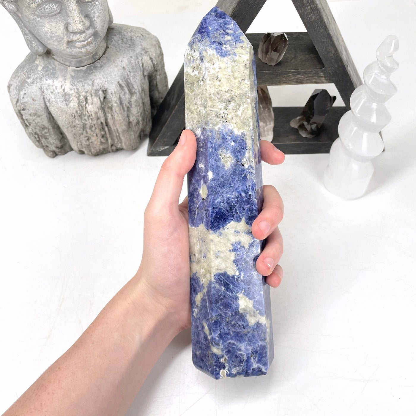 sodalite polished point in hand for size reference