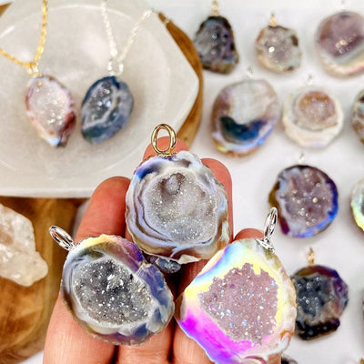 geode half pendants with an angel aura coating and an electroplated silver or gold bail