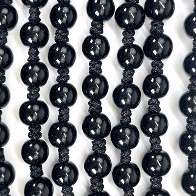 close up of black obsidian mala beads for details