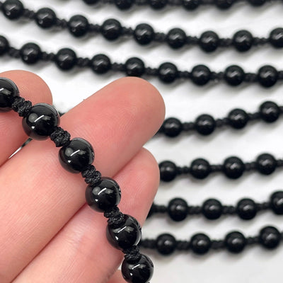 close up pf black obsidian mala beads with others in the background
