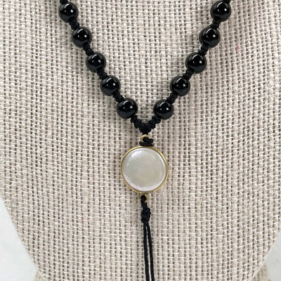 close up of center string with pendant attached (not included with purchase)