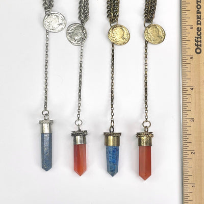 close up of pendants with ruler for size reference