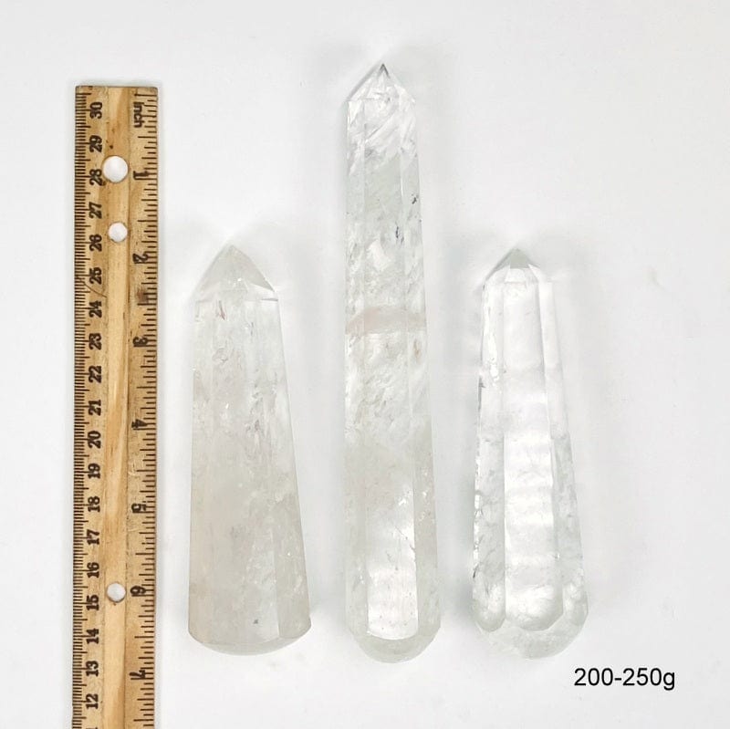 crystal quartz massage wands next to a ruler for size reference. showing possible sizes for 200-250g