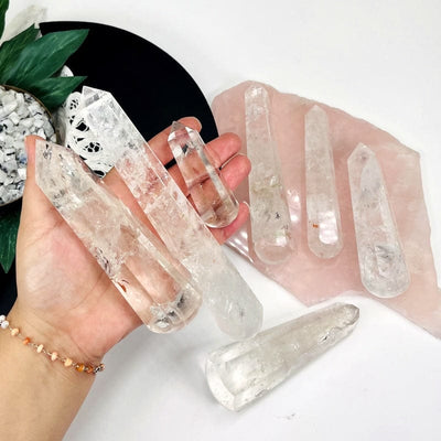 multiple crystal quartz massage wands in hand for size reference 