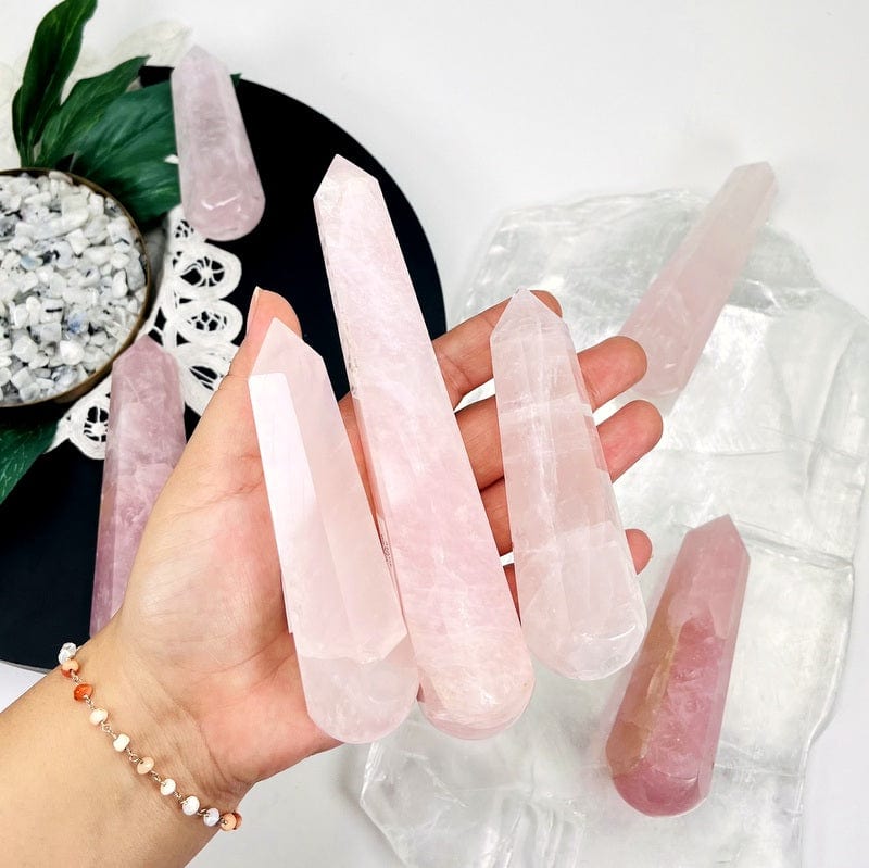 rose quartz massage wands in hand for size reference 