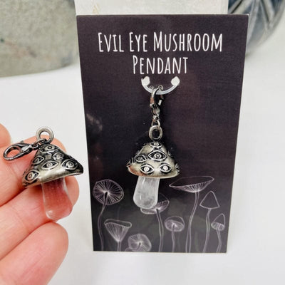 antique silver mushroom pendant in hand for size reference 
