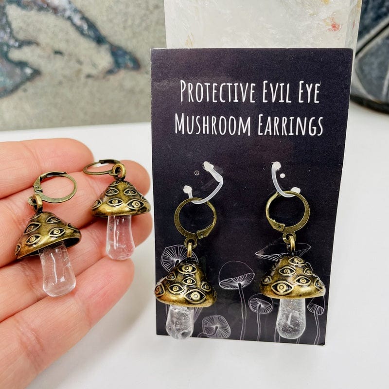close up of the antique gold evil eye mushroom earrings