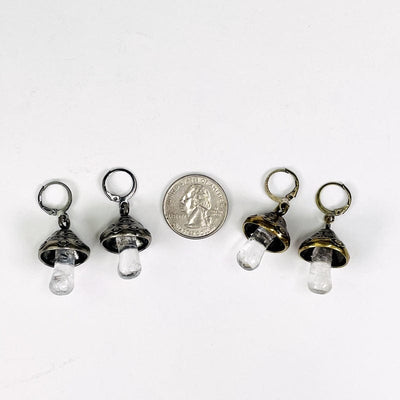 earrings displayed next to a quarter for size reference 