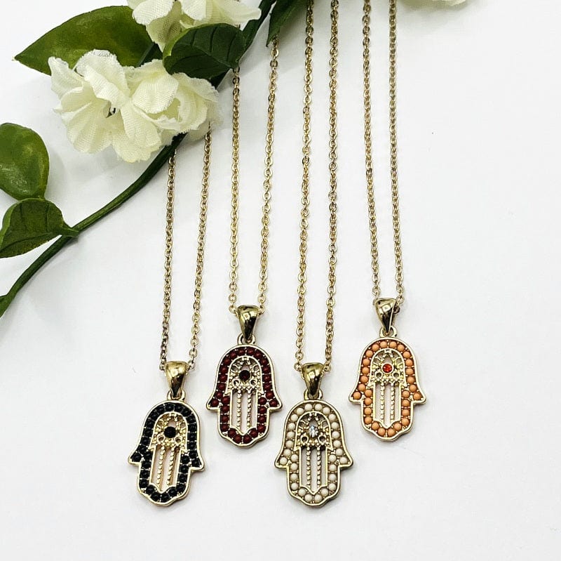 hamsa hand necklaces displayed next to each other to show accent details 