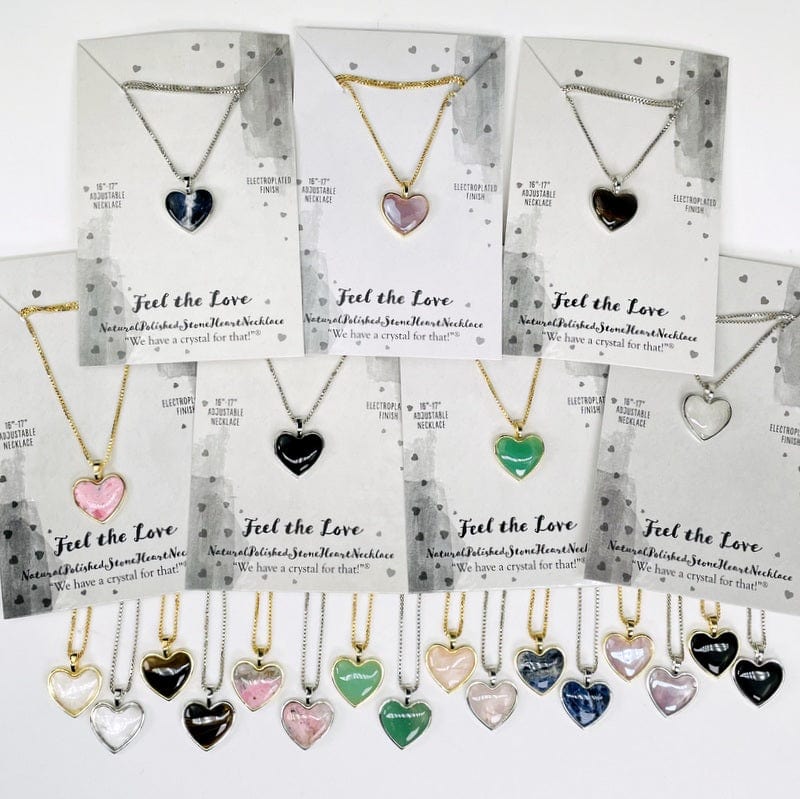 multiple heart shaped stone necklaces displayed to show the differences in the gemstones