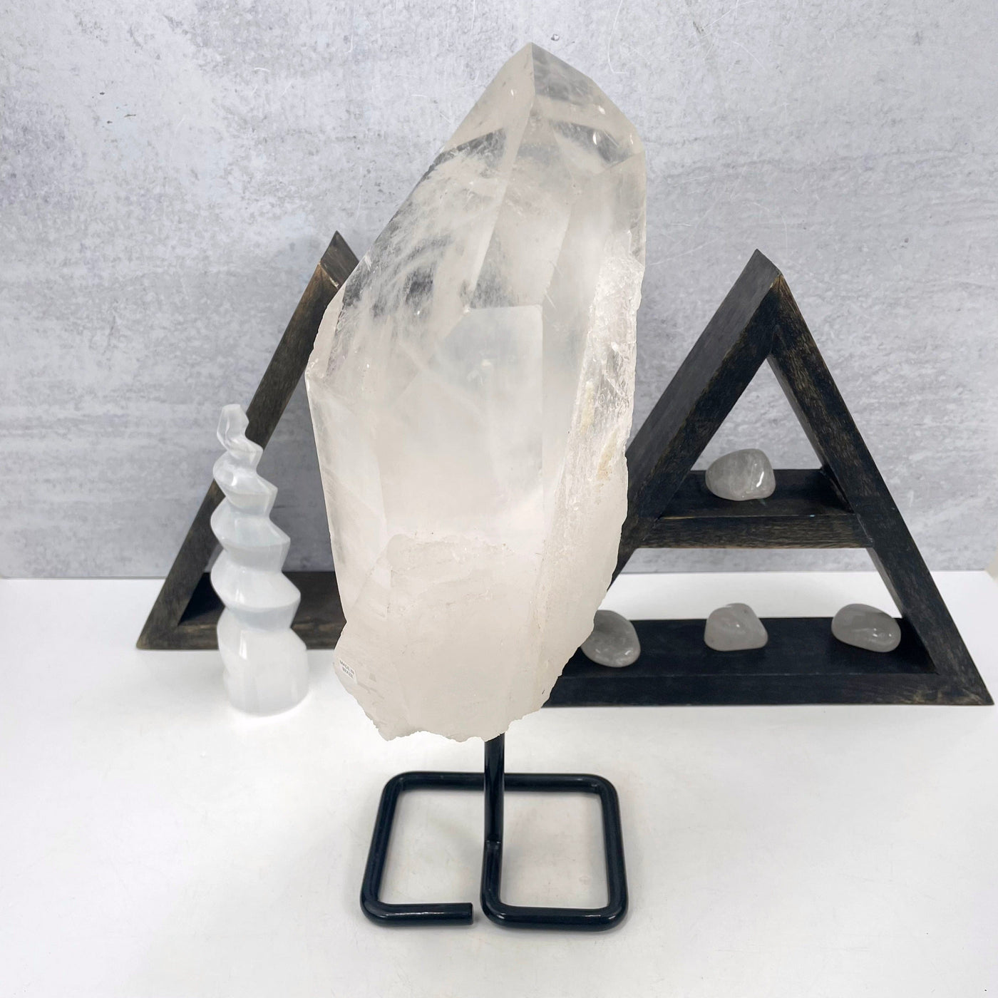 side view of crystal quartz semi-polished point on metal stand for thickness