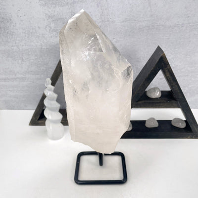side view of crystal quartz semi-polished point on metal stand for thickness