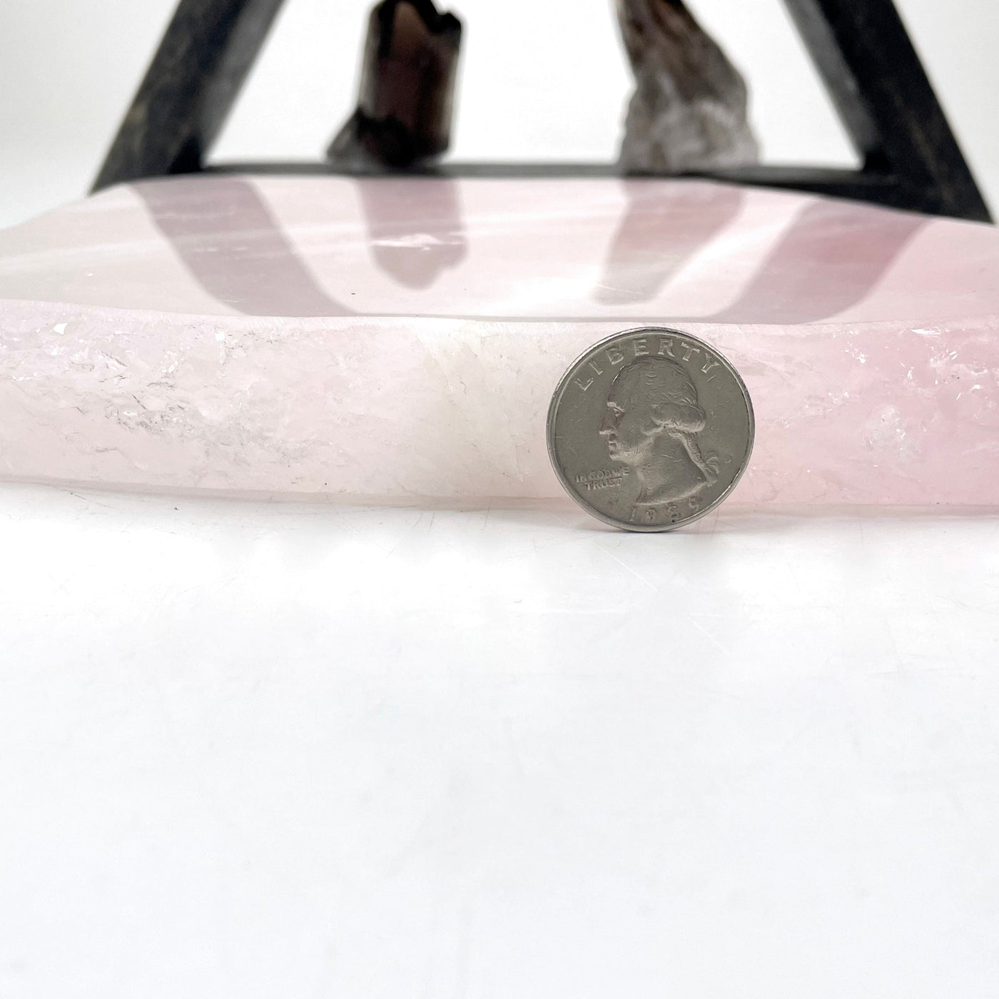 side view of rose quartz platter with quarter for thickness
