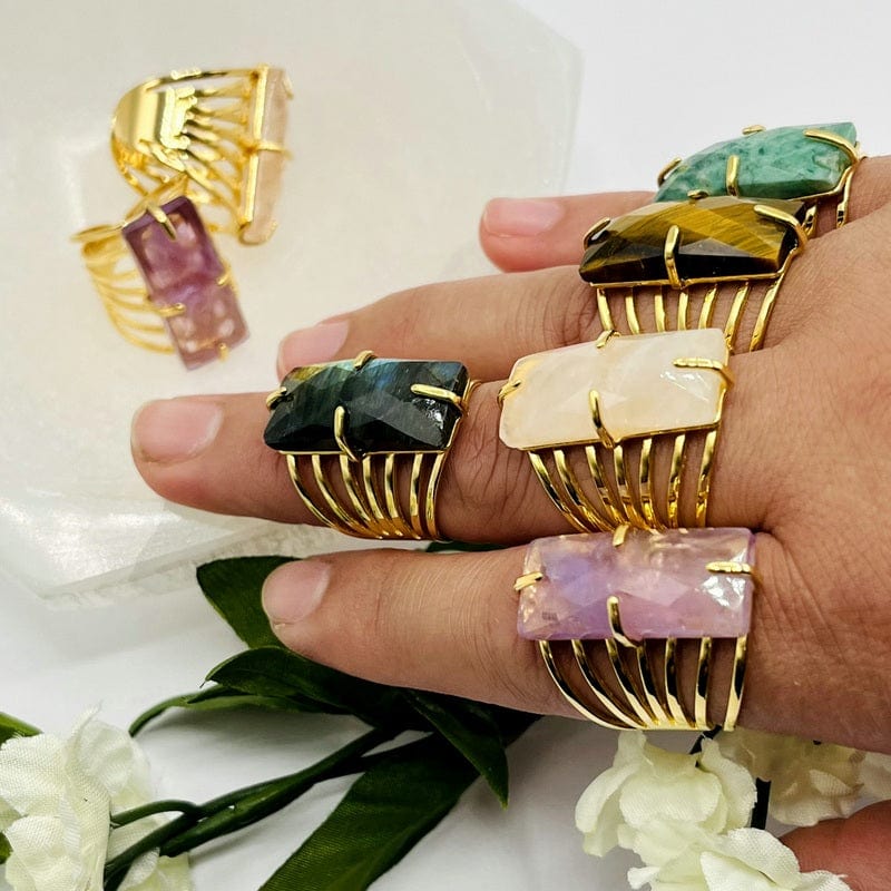 multiple gemstone rings on hand showing the differences in the gemstones 