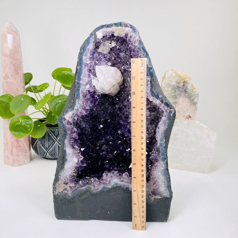 amethyst next to a ruler for size reference 