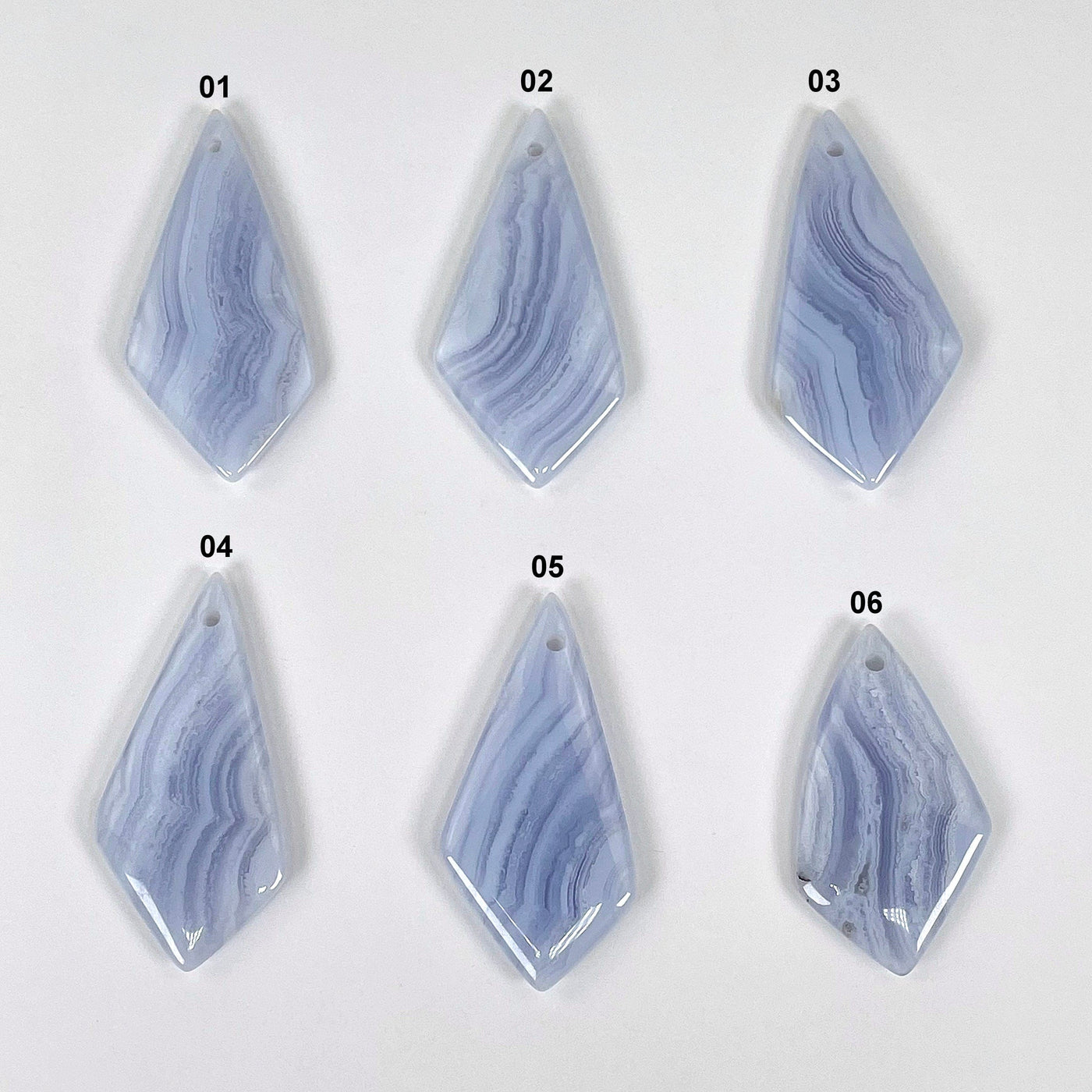 all blue lace agate polished diamond pendants on display