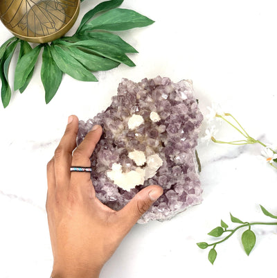 Hand comparing size to the Amethyst Cluster with Calcite