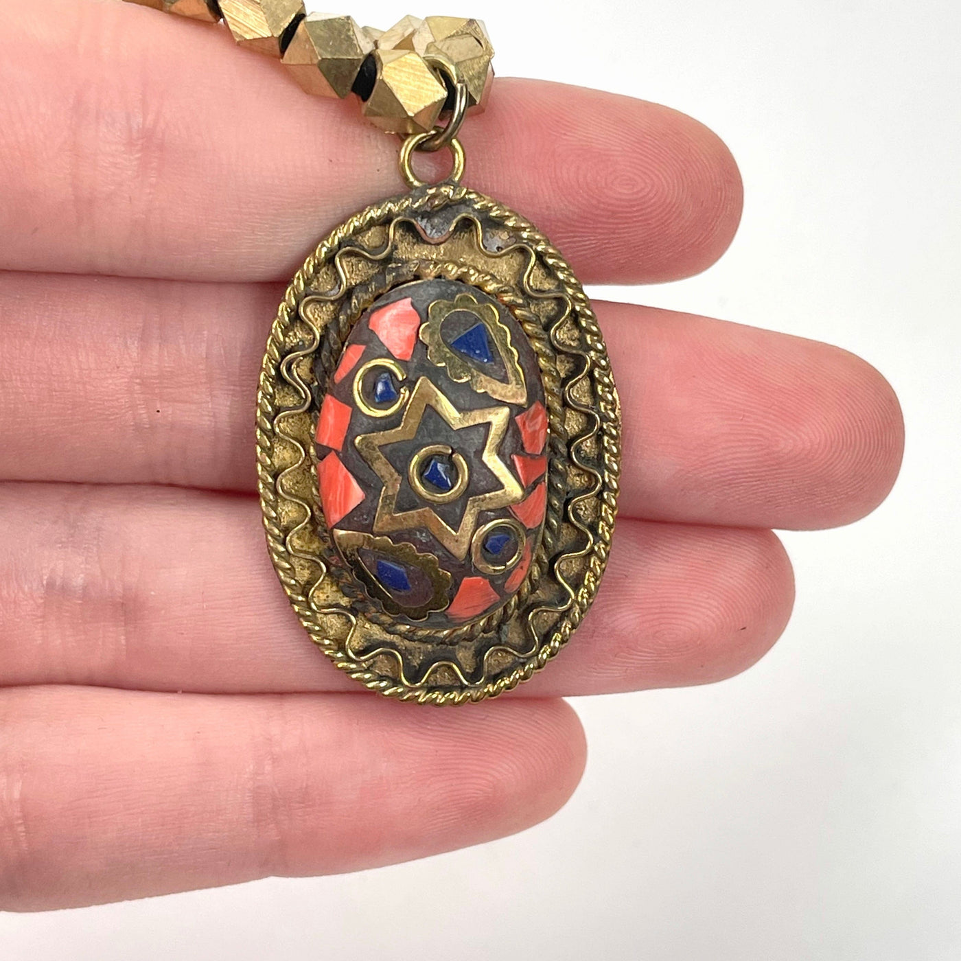 close up of last tier pendant in hand for size reference and details