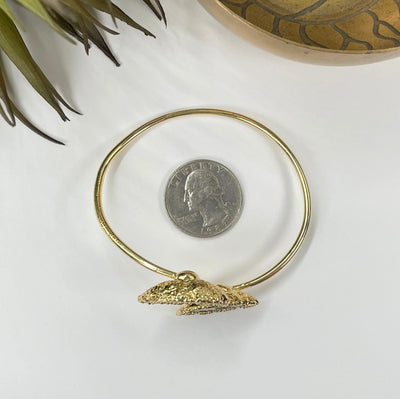 overhead view of geode pair bracelet with electroplated gold edge with quarter for size reference