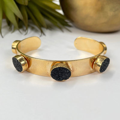 close up of adjustable druzy cuff bracelet in electroplated gold for details