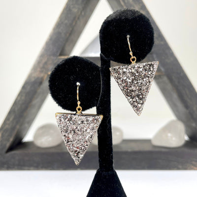 close up of druzy earrings with electroplated gold edge on earring display for details